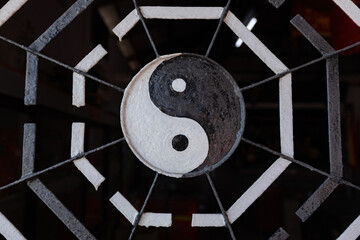 Yin yang black and white sign at the Buddhist temple gate