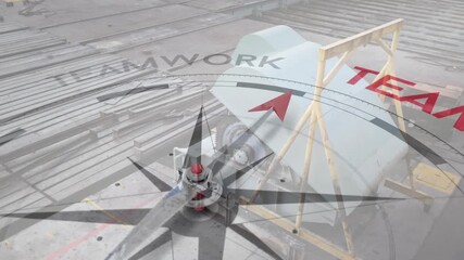 Animation of compass with arrow pointing to teamwork text over industrial machinery - Powered by Adobe