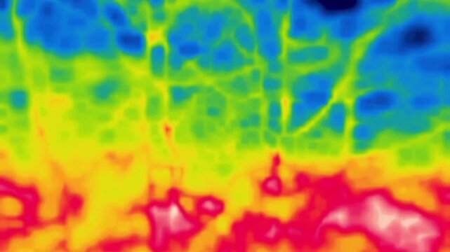 A man walks through the woods, parkland. Image from thermal imager device.
