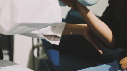Physical therapist doctor teach senior man patient using dumbbell exercise for chest and arms muscle at Physiotherapy clinic. Medical wellness healthcare and physical rehabilitation in elderly people. - Powered by Adobe