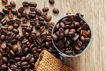 Fototapeta premium Close-up of Fresh Coffee Beans in Metal Bucket on Wooden Surface