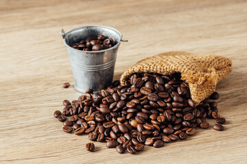 Fresh Coffee Beans Spilling from a Burlap Sack on Wooden Surface