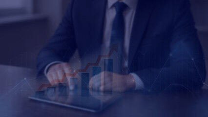 A businessman is analyzing data to plan business strategies for investment.