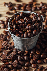 Fototapeta premium Freshly Roasted Coffee Beans in a Vintage Metal Bucket on Wood