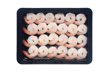 Top view of frozen cooked peeled white shrimp arranged in rows in a black plastic tray isolated on a transparent background.