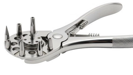 Silver rotary punch tool with multiple interchangeable heads on png isolated transparent background black background