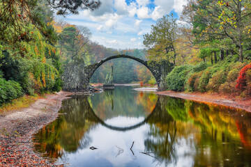 Amazing autumn landscape in Kromlau Rhododendron Park . Rakotz Bridge (Rakotzbrucke, Devil's Bridge)
