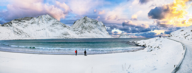 Amazing winter view of Vik and Haukland beaches during sunset with lots of snow  and snowy  mountain peaks near Leknes