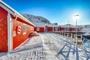 Amazing scenery with traditional Norwegian red wooden houses on the shore of  Sundstraumen strait.