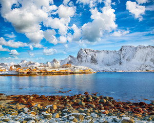 Amazing winter view of Sakrisoy village and snowy mountaines on background.