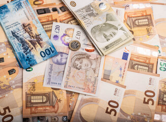 Group of European currencies: Euro, Pound, Swiss Franc, and Serbian Dinar. Top view. No people..