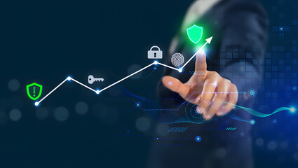 Cyber Security and Financial Growth Concept: Businessman Touching Digital Growing Graph with Icon Protection, Lock, Key and Fingerprint Scanner on Blue Background for Data Privacy and Safety.