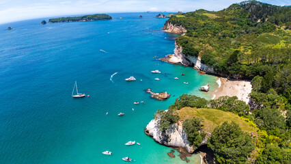 Fototapeta premium Aerial View of Cathedral Cove Beach, New Zealand – Turquoise Waters and Coastal Cliffs