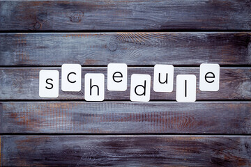 Paper cards with the text Schedule, top view.