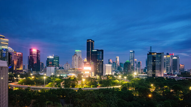 Jakarta, Indonesia - 1 Jan 2022: View of Jakarta's Central Business District cityscape at sunset. Simpang Susun Semanggi (Semanggi Interchange) is also visible.