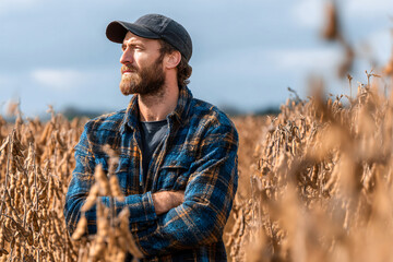 Farmer standing proudly with crossed arms in soybean field during golden hour Generative AI