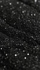 Abstract dark grainy texture on black background, perfect for artistic photography projects.