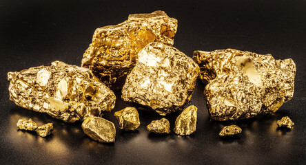 Glittering gold nuggets on black background. Imitation of gold nuggets.