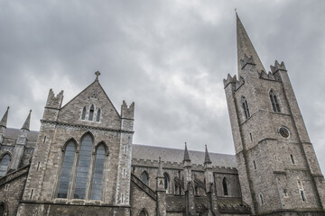 Exterior of St Patrick's Cathedral in Dublin, Ireland against a cloudy sky