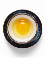 Fresh raw egg yolk presented in a rustic ceramic bowl, symbolizing natural ingredients and wholesome nutrition
