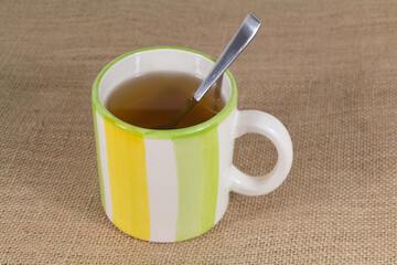 Cup of tea and teaspoon