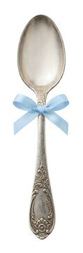 Antique silver spoon tied with blue ribbon bow
