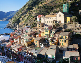 Fototapeta premium View of Vernazza, town in Cinque Terre, from mountain. Nature and sea, traditional buildings of Liguria, Italy. Architecture protected by UNESCO. Background for design. 