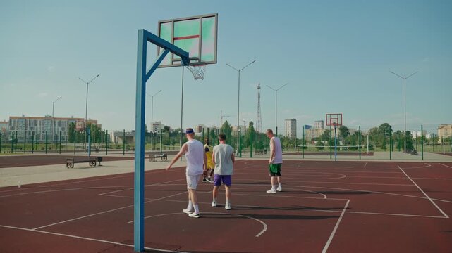 A basketball player misses a three-point shot. The basketball players play on the court.