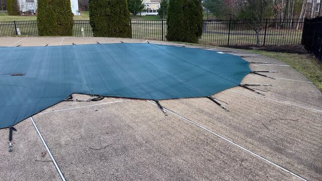 Residential swimming pool winterized safety cover during cold winter season