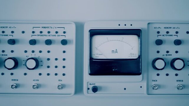 Old control panel for monitoring and adjusting the current in the system. Closeup. Shot in motion. Translation:"выкл"-off, "пуск"-start, "неиспр"-malfunction, "мощность"-power,  "источник"-source,  
