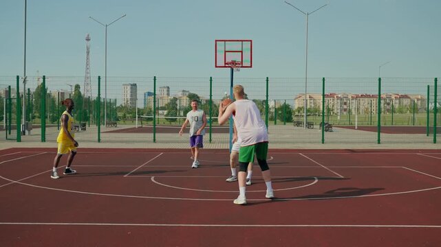 A basketball player misses a three-point shot and gets upset. The basketball players play on the court.