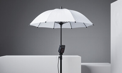 Empty Light Modifier. A large, white umbrella light modifier is open and standing on its own, but the flash head