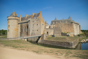 Entire view of Suscinio Castle surrounded by its moat on a sunny day. Background with copy space, no people. Sarzeau, Brittany, France.