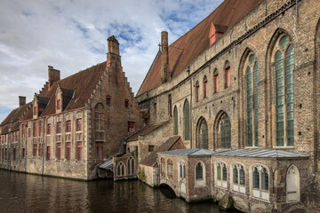 Obraz premium View from Mary's Bridge (Mariabrug) of Saint John’s Hospital (Museum Sint-Janshospitaal) and medieval buildings in Bruges, Belgium