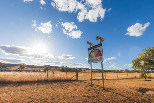 Extreme fire danger risk warning sign in rural New South Wales with sunflare