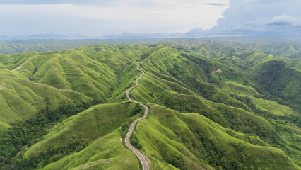 The beautiful and winding roads at the hilltops and across the savanna valleys when the grasses turn green 