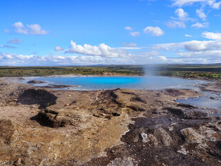 Great Geysir or geyser with bright blue water, close up. Iceland. Geysir Geothermal area, Haukadalur Valley, home to Iceland's most iconic hot springs and is key stop on the famous Golden Circle route
