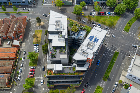 Aerial view of V shaped high rise apartments building surrounded by busy city streets
