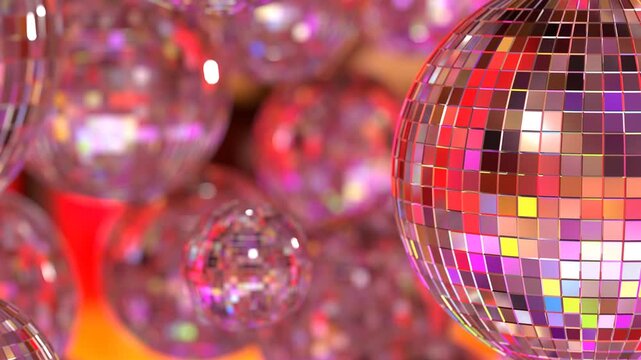 Close-up of multiple disco balls against a dark background, reflecting vibrant light patterns Spherical, metallic disco balls with dynamic lighting, creating warm to cool tones Hanging by fine stri