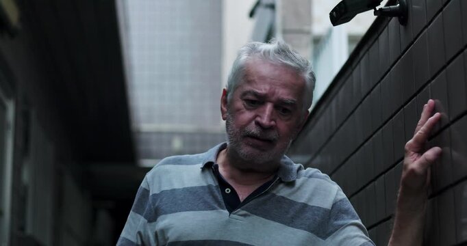 Senior man walking slowly forward in narrow corridor, physical and emotional struggle, exhaustion, determination, facing hardship step by step