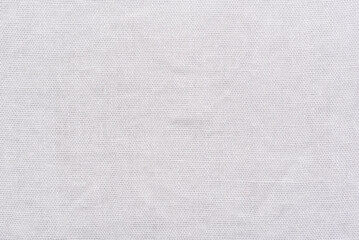 Detailed macro shot of a light gray cotton material surface.