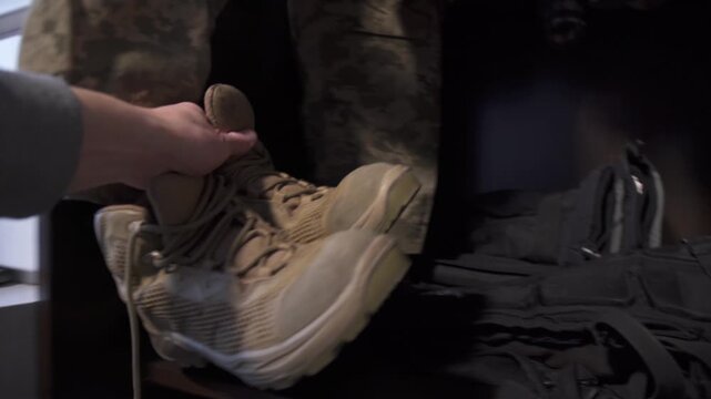 A military uniform and combat boots in a closet. A veteran's memories of his military service. The theme is returning home from war.