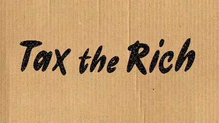 Sign reading "Tax the Rich" on brown cardboard