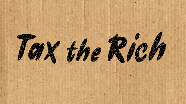 Sign reading "Tax the Rich" on brown cardboard