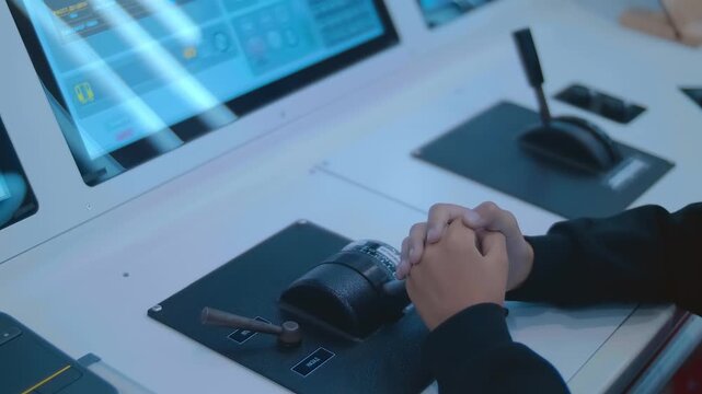 A train driver apprentice learns to master the profession flawlessly using a modern electronic simulator with multiple displays and levers