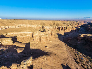 Shadows play on the rocks of the Charyn Canyon. Drone view.