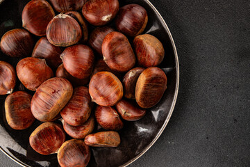 Obraz premium Edible chestnuts delicious treat tasty snack fresh gourmet food background on table rustic food top view copy space