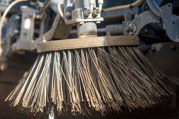 Street cleaning vehicle operates on construction site  removing debris and dust for improved visibility and safety