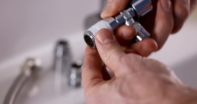 Plumber apply teflon seal tape on the plumbing fitting thread