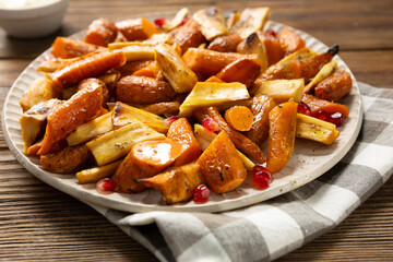 Oven baked winter roots carrots and parsnips close up